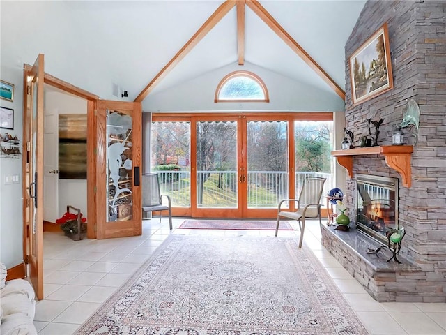 living area featuring french doors, a fireplace, tile patterned flooring, and beam ceiling