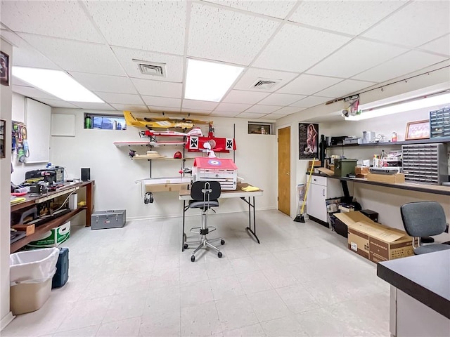 home office featuring a drop ceiling, visible vents, and baseboards