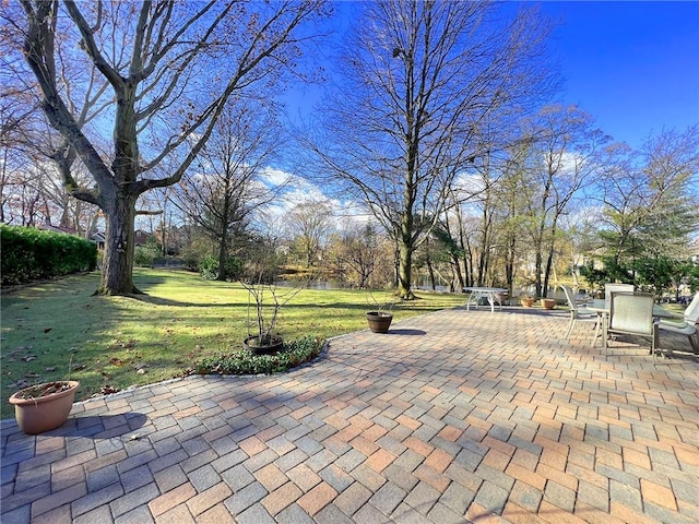 view of community with a yard and a patio area