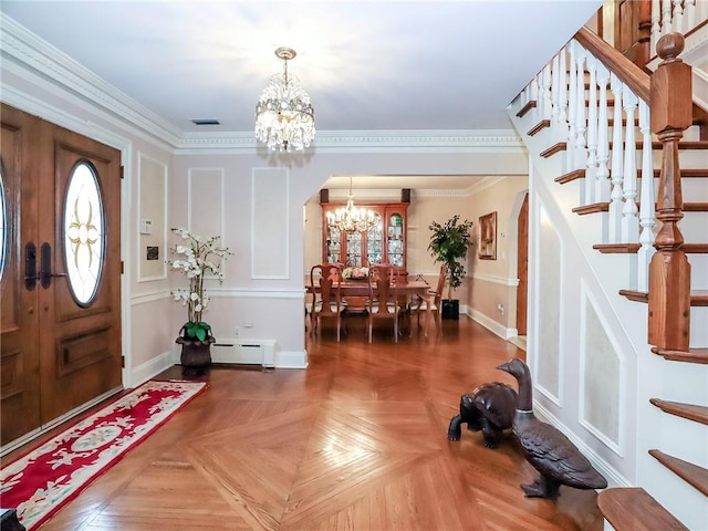 foyer featuring baseboard heating, arched walkways, an inviting chandelier, and stairs