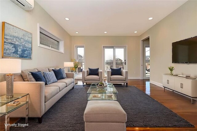 living room with dark hardwood / wood-style floors and a wall mounted AC