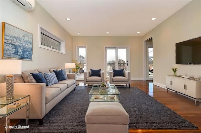 living room featuring recessed lighting, baseboards, wood finished floors, and a wall mounted AC