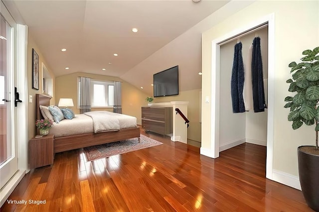 bedroom with vaulted ceiling, recessed lighting, wood finished floors, and baseboards