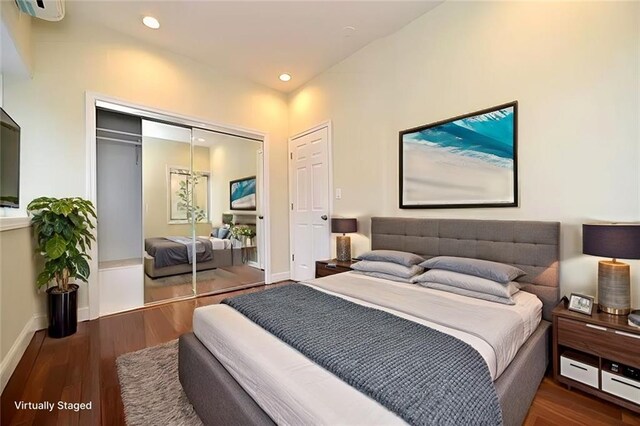 bedroom featuring dark wood-type flooring and a closet