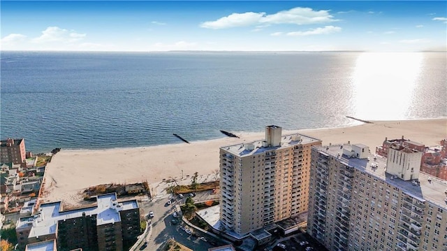 aerial view with a water view and a beach view