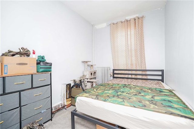 bedroom featuring radiator and light carpet