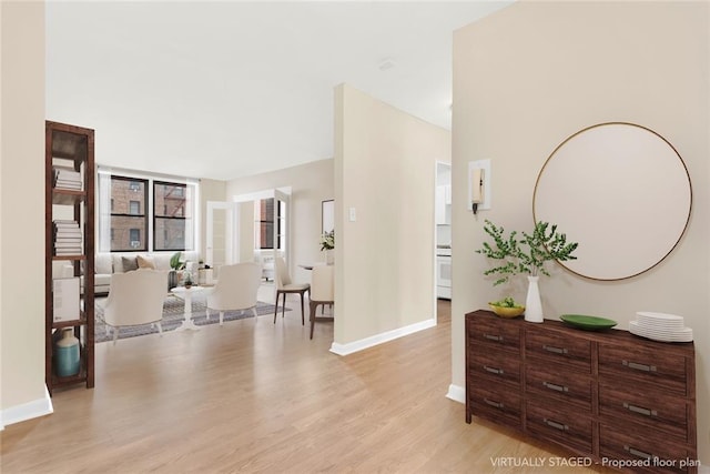 entrance foyer with light wood-style flooring and baseboards