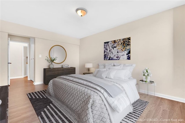 bedroom with wood finished floors and baseboards