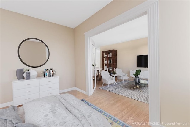 bedroom featuring light wood-type flooring and baseboards