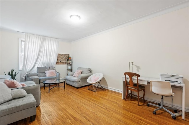 office area with ornamental molding and light wood-type flooring