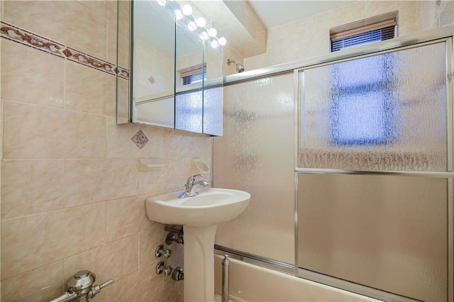 full bath featuring shower / bath combination with glass door