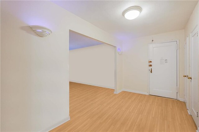 interior space featuring light floors and baseboards