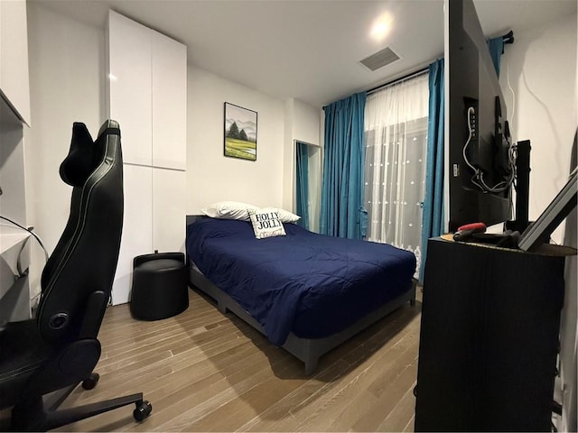 bedroom with wood-type flooring