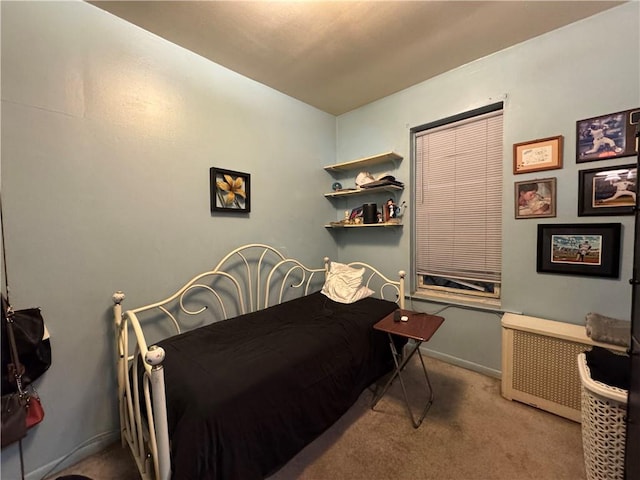 bedroom featuring light carpet and radiator heating unit