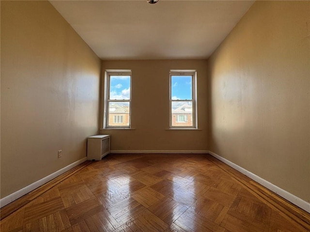 unfurnished room featuring parquet flooring