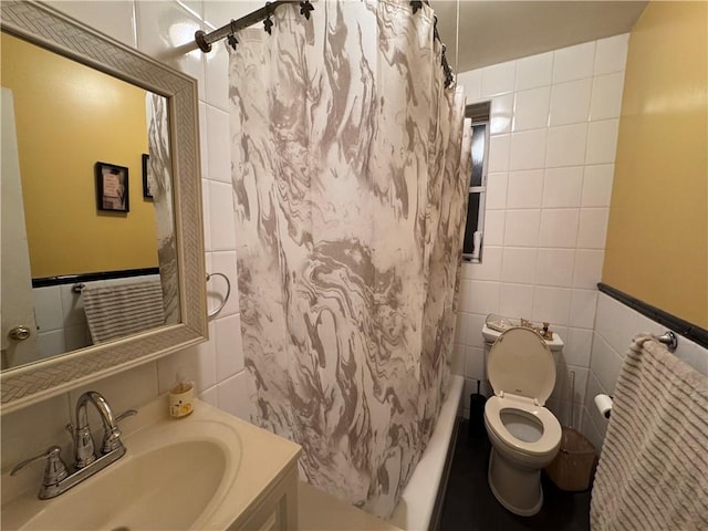 full bathroom featuring vanity, tile walls, shower / tub combo, and toilet