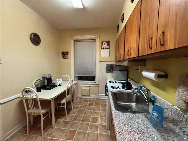 kitchen with tile patterned flooring and sink