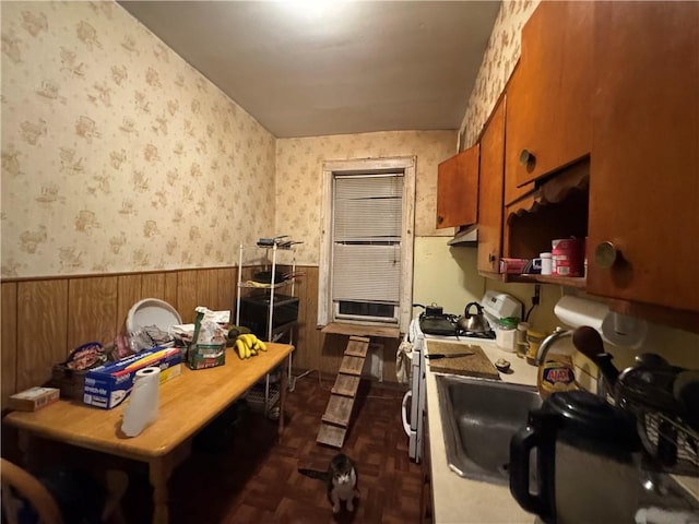 kitchen featuring white gas stove and dark parquet floors