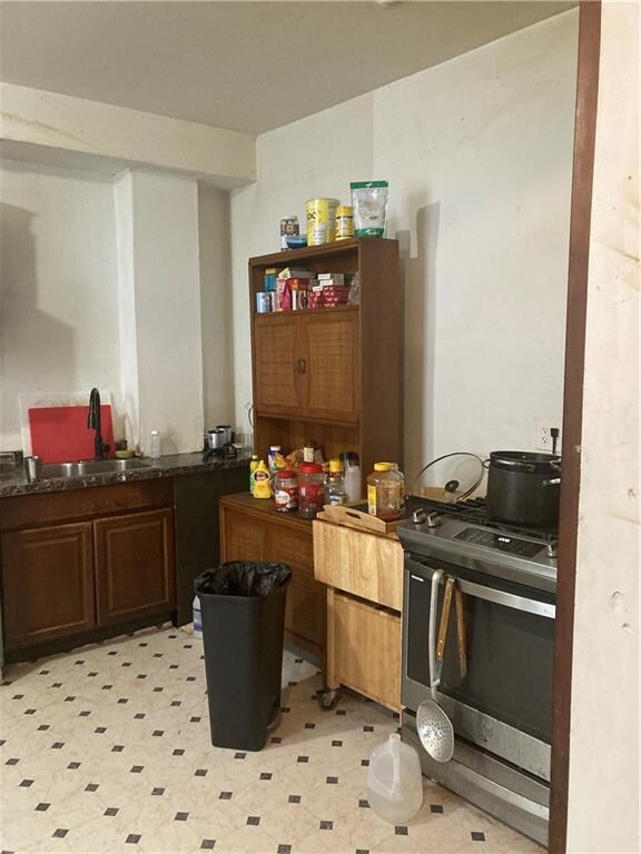 kitchen featuring stainless steel range oven and sink