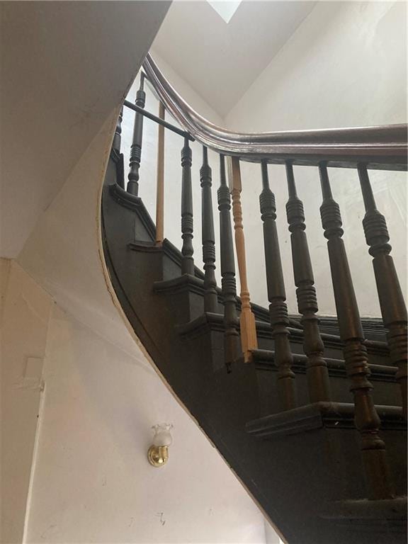 staircase featuring lofted ceiling