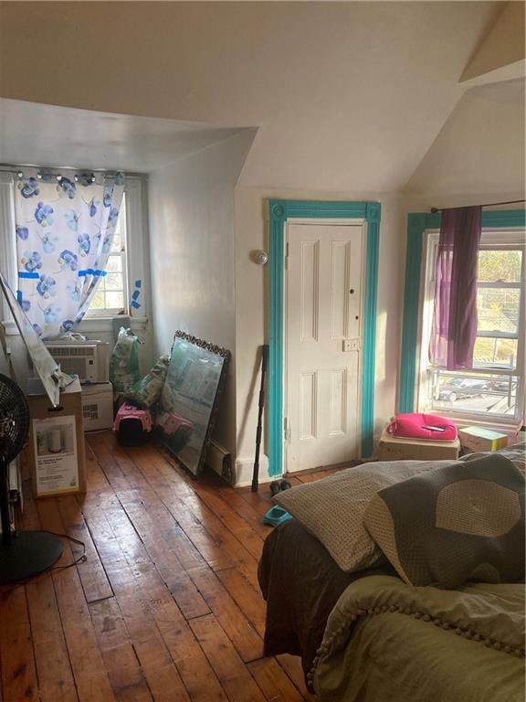 bedroom featuring cooling unit, vaulted ceiling, and hardwood / wood-style floors