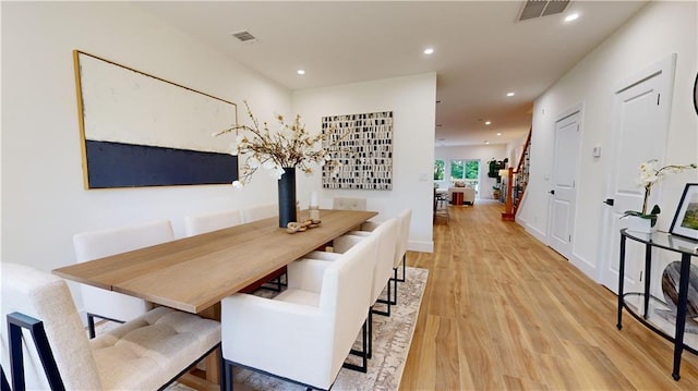 dining space with light hardwood / wood-style flooring