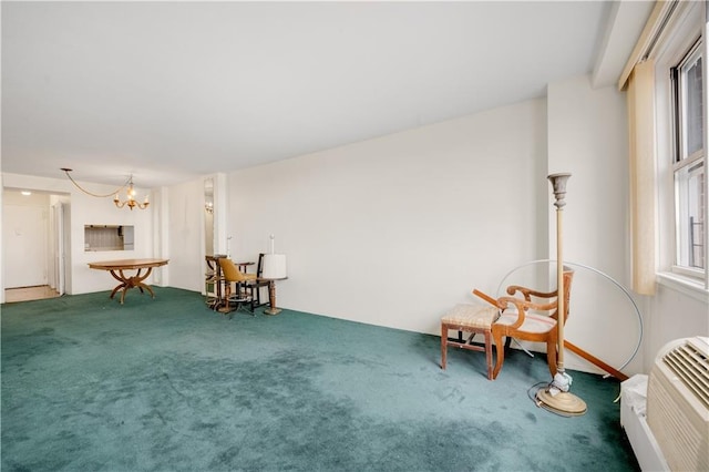 unfurnished room with carpet, a wall mounted air conditioner, and an inviting chandelier