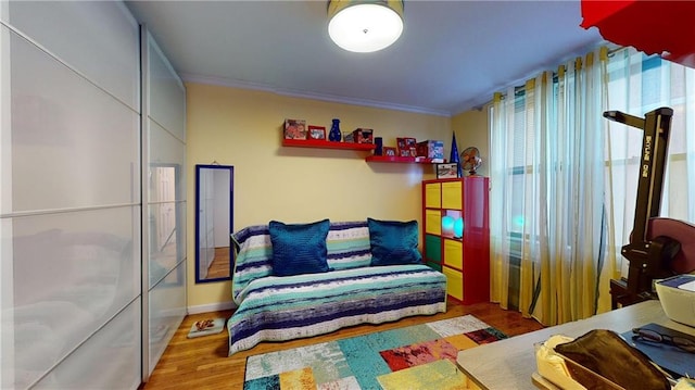 bedroom featuring crown molding and hardwood / wood-style flooring