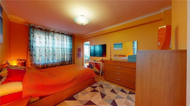 bedroom featuring hardwood / wood-style floors and crown molding