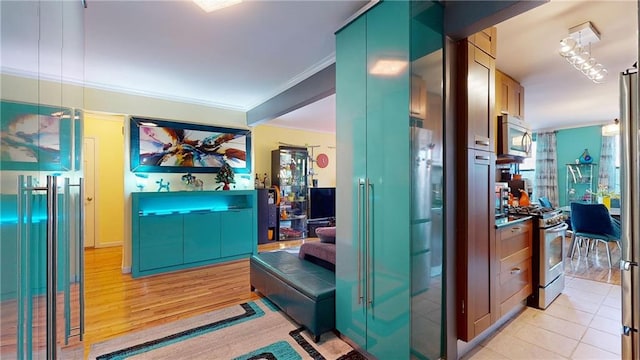 corridor with light hardwood / wood-style floors and ornamental molding