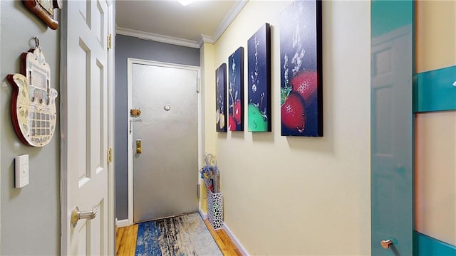 doorway with hardwood / wood-style flooring and ornamental molding