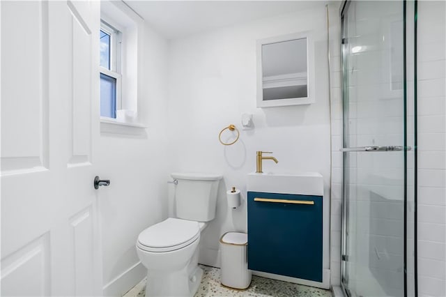 bathroom featuring vanity, toilet, and an enclosed shower