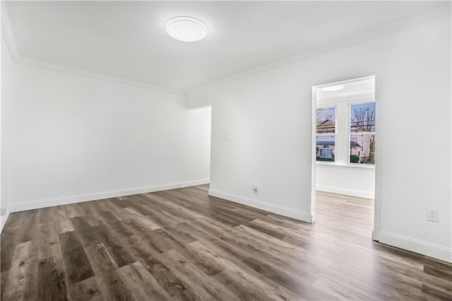 empty room featuring crown molding and dark hardwood / wood-style floors