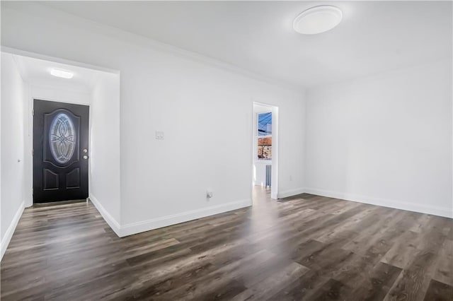 foyer entrance featuring ornamental molding and dark hardwood / wood-style flooring