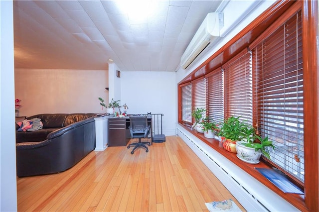 office area featuring a baseboard radiator and wood-type flooring