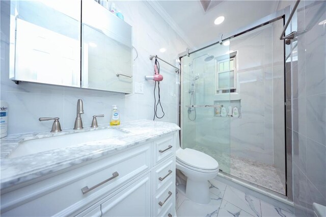 bathroom with vanity, ornamental molding, decorative backsplash, a shower with shower door, and toilet