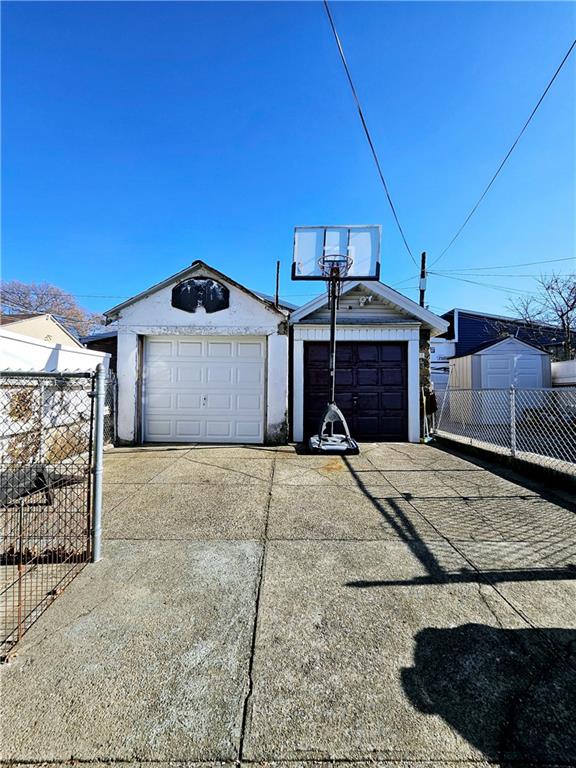 detached garage featuring fence