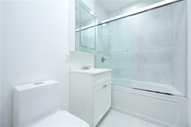 full bath featuring vanity, toilet, marble finish floor, and enclosed tub / shower combo