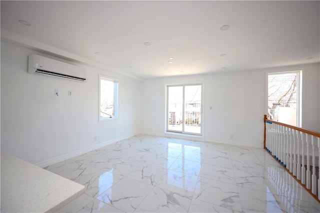 empty room with a wall unit AC and plenty of natural light