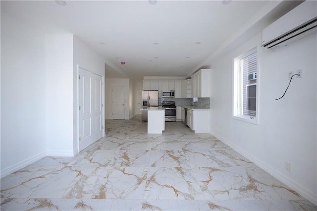 unfurnished living room featuring sink and a wall unit AC