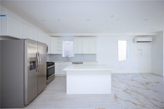 kitchen featuring sink, a kitchen island, white cabinetry, stainless steel appliances, and a wall unit AC