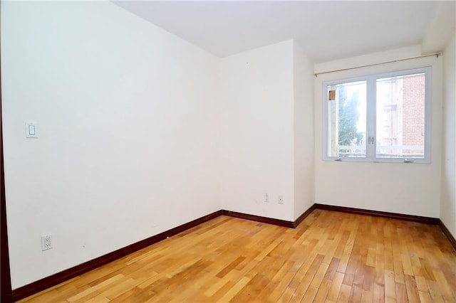 unfurnished room featuring light wood-style floors and baseboards