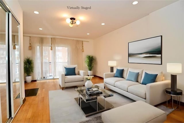 living area featuring light wood-style flooring and recessed lighting