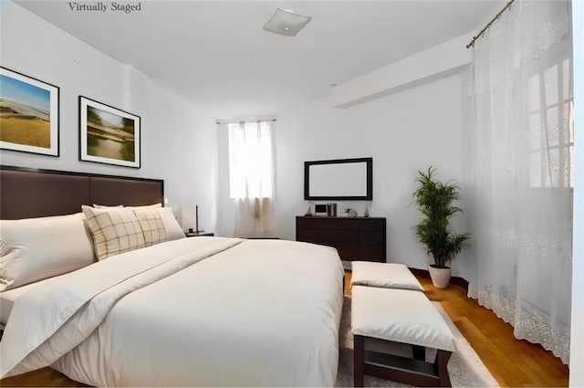 bedroom featuring wood finished floors