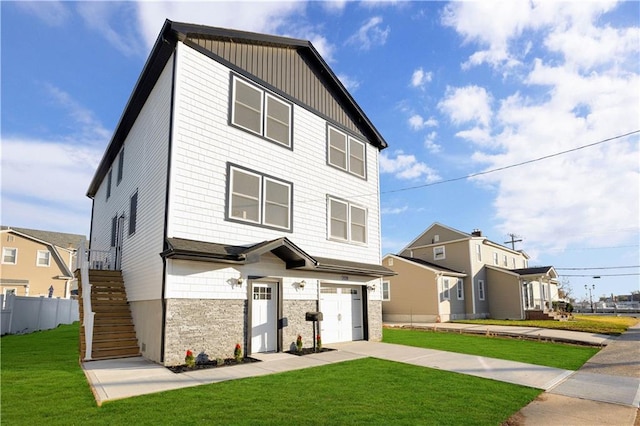 view of front of house featuring a garage and a front lawn