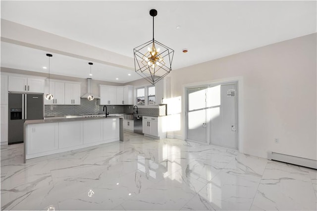 kitchen featuring a notable chandelier, a kitchen island, stainless steel appliances, and white cabinetry