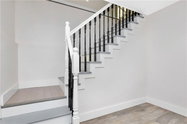 staircase featuring hardwood / wood-style floors