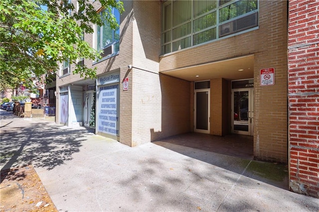 property entrance featuring brick siding