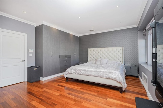 bedroom with light hardwood / wood-style flooring and crown molding