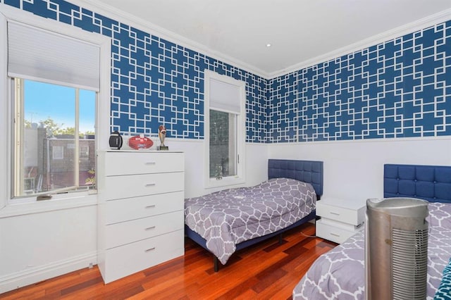 bedroom with hardwood / wood-style floors and ornamental molding